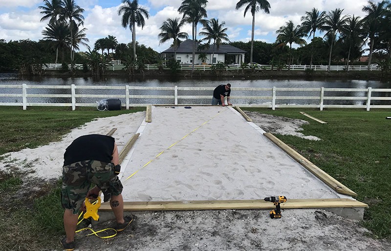 Measuring for the placement of a custom coop build in Delray Beach, Florida