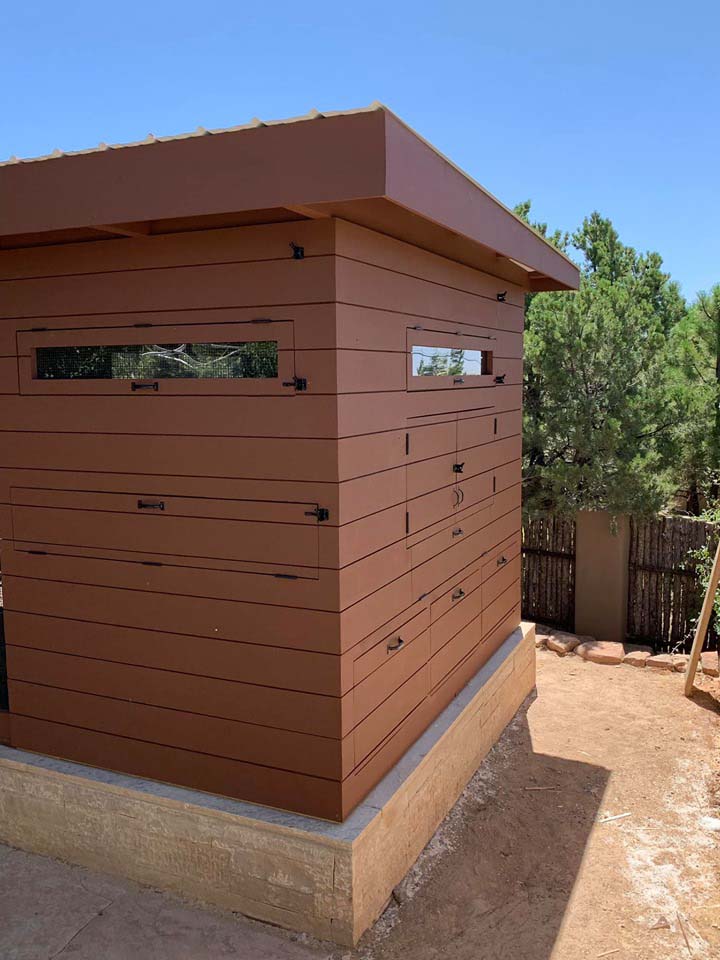 Exterior of a henhouse of a custom modern chicken coop with shiplap siding in Santa Fe, NM