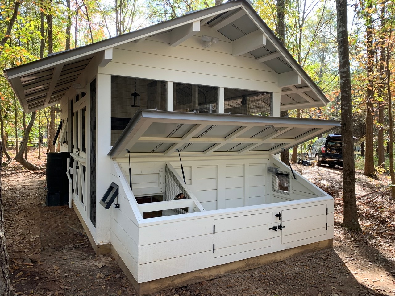 Modern farmhouse chicken and duck coop has a duck dipper for ducks to get their heads wet