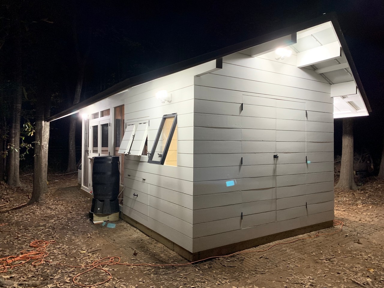 Modern farmhouse custom chicken and duck coop at night