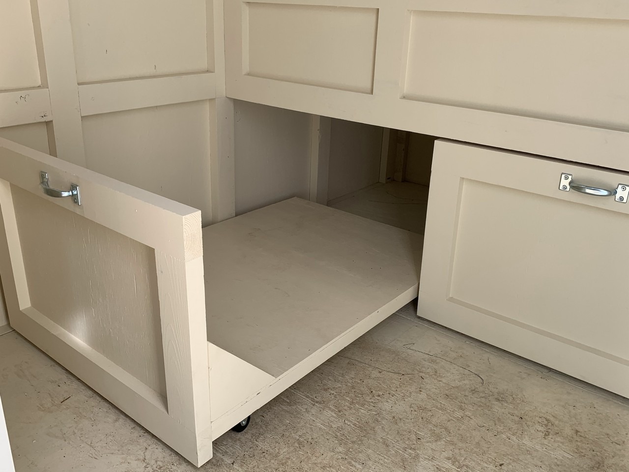 Pull out storage drawers in the shed-henouse combo of a custom Craftsman Coop in Santa Barbara, CA