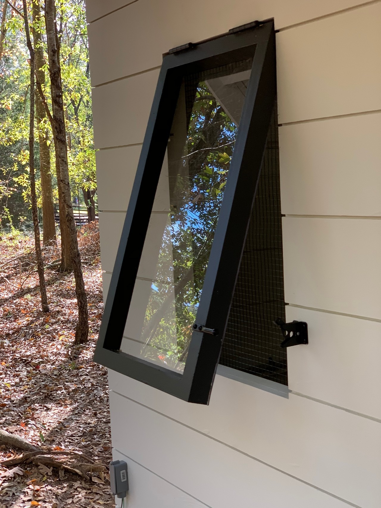 close up on the tilt out windows on the modern farmhouse chicken and duck coop in South Carolina