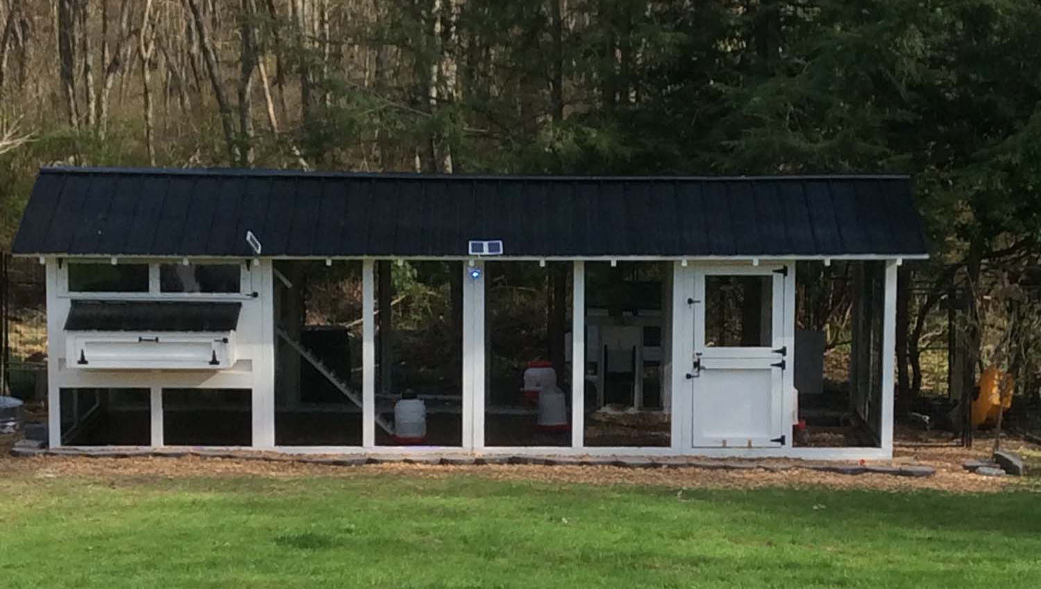 8’x24′ American Coop with 6’x8′ henhouse in Norwell, MA with black roofing & hardware and Dutch door